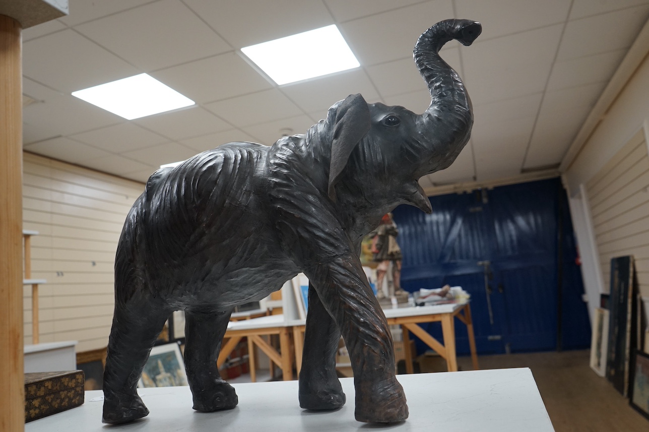 A large Liberty style leather elephant, 64cm wide. Condition - fair, minor repairs